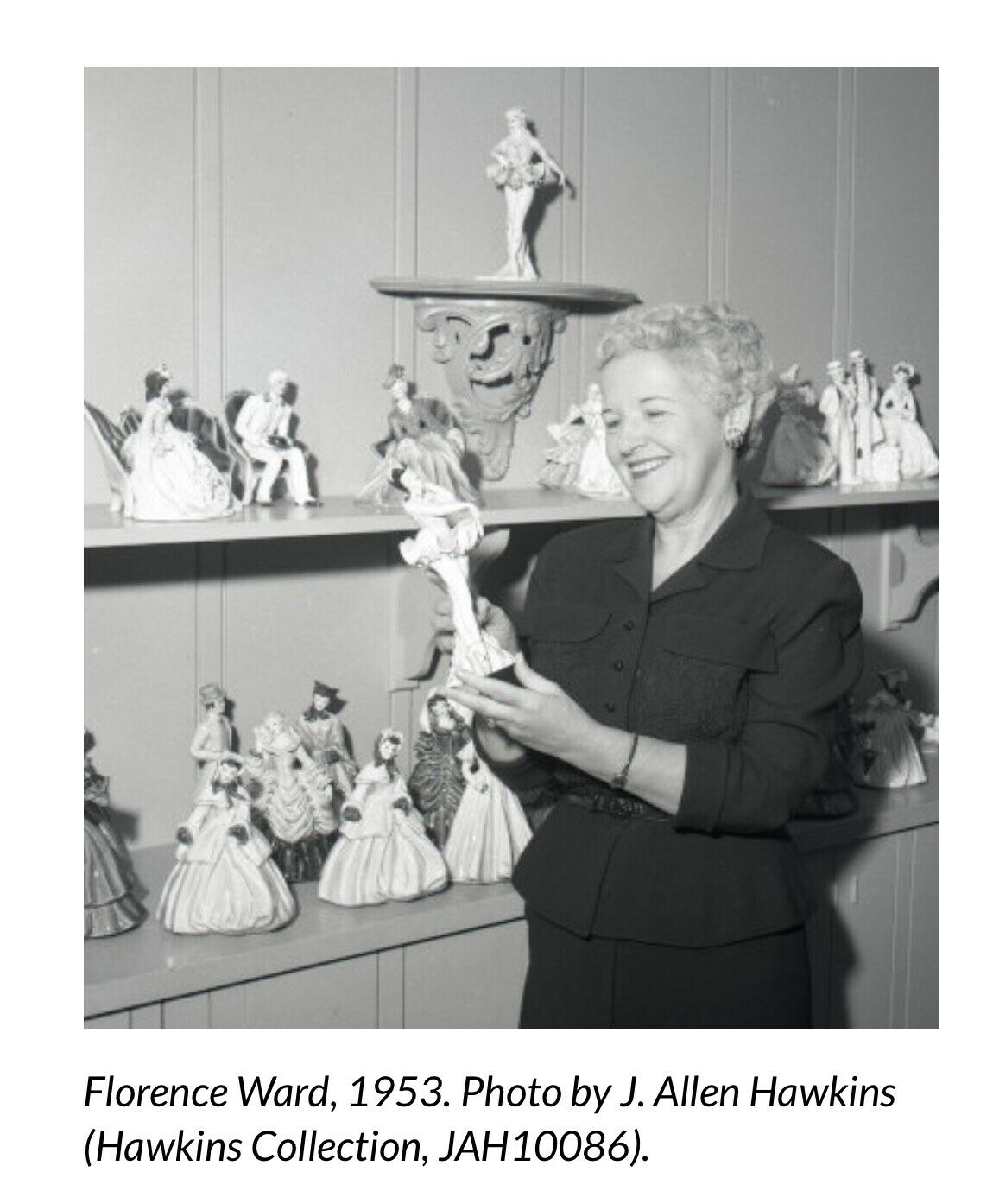 1953 photo of Florence Ward admiring porcelain doll.